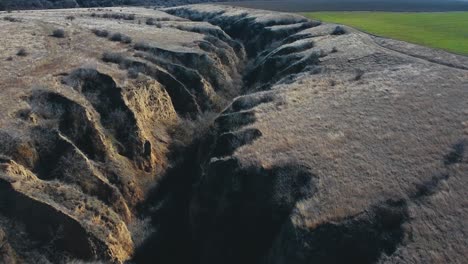 flying forward drone shot over a canyon in loess soil at the allah bair nature reservation located in constanta county, dobrogea region of romania