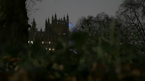 uk parliament and london eye illuminated at night still shot