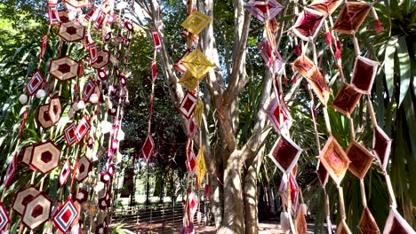 vibrant mobiles hanging among lush greenery