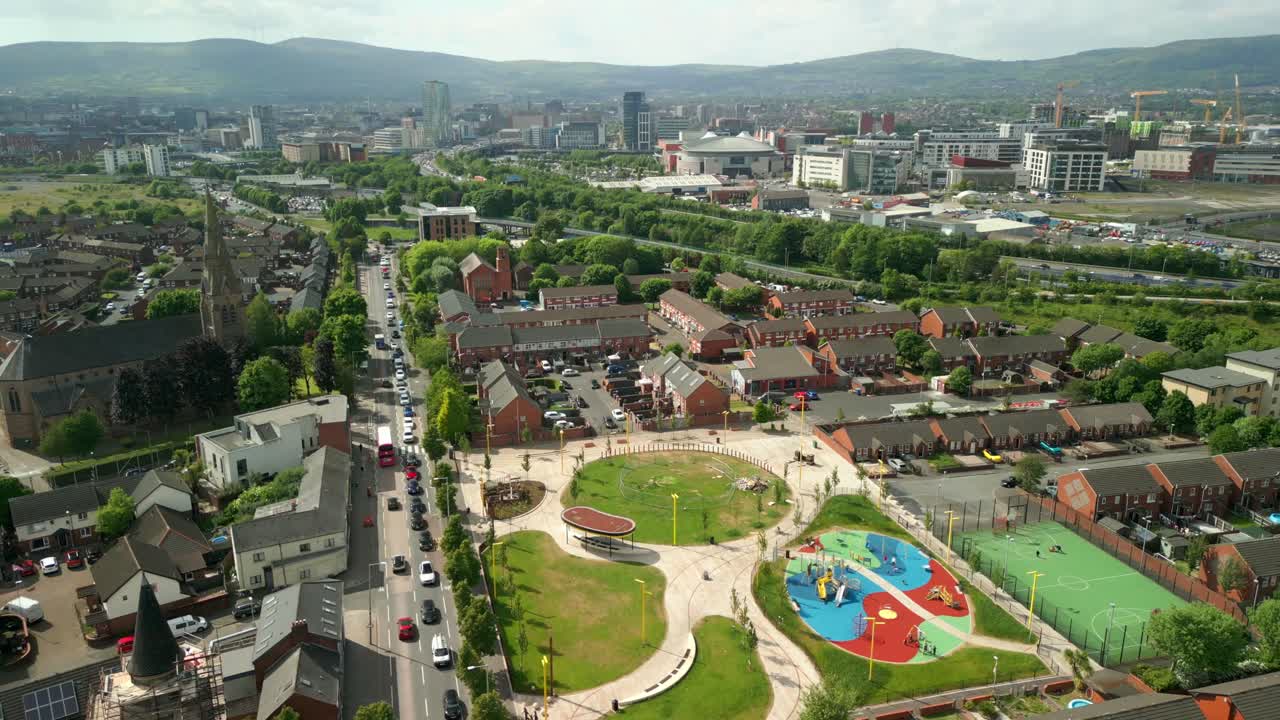 Side-on overhead aerial video of the Newtownards Road in East Belfast, Northern Ireland on a bright sunny day. Filmed in 4K, 60FPS and with Rec709 color.