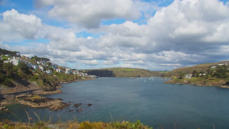 blue sky cloudscape panoramic view of fowey river estuary on the cornwall coastline - timelapse