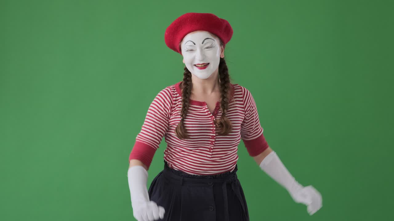 Mime artist greeting and showing heartfelt gratitude towards her fans from the stage