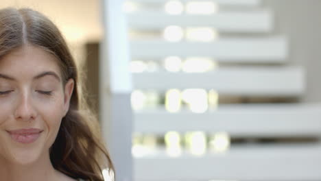 smiling woman with long hair looking at camera, indoors at home, copy space