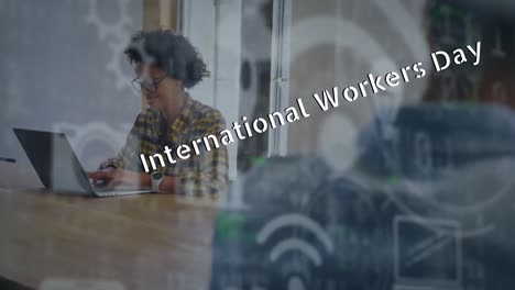 Animation-of-international-workers-day-text-over-diverse-business-people-in-office