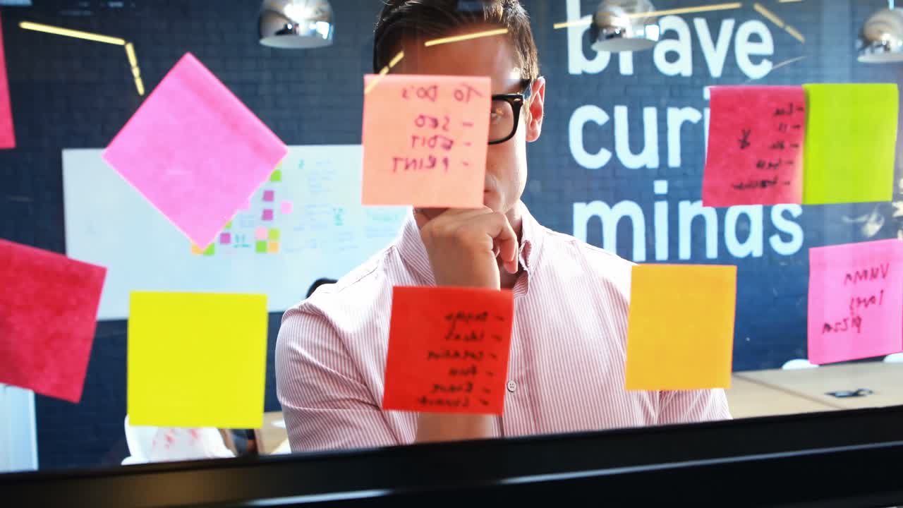 Businessman looking at the sticky notes