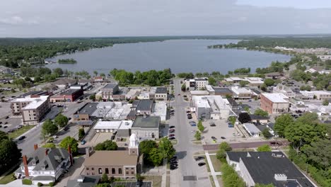 downtown cadillac, michigan with drone video moving down wide shot