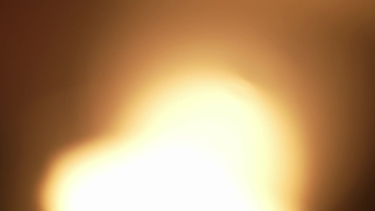 Sfondo con perdita di luce dorata radiosa e una messa a fuoco morbida e calda. Bellissimo elemento di sovrapposizione con bagliore dell'obiettivo sfocato per transizioni oniriche e narrazione cinematografica