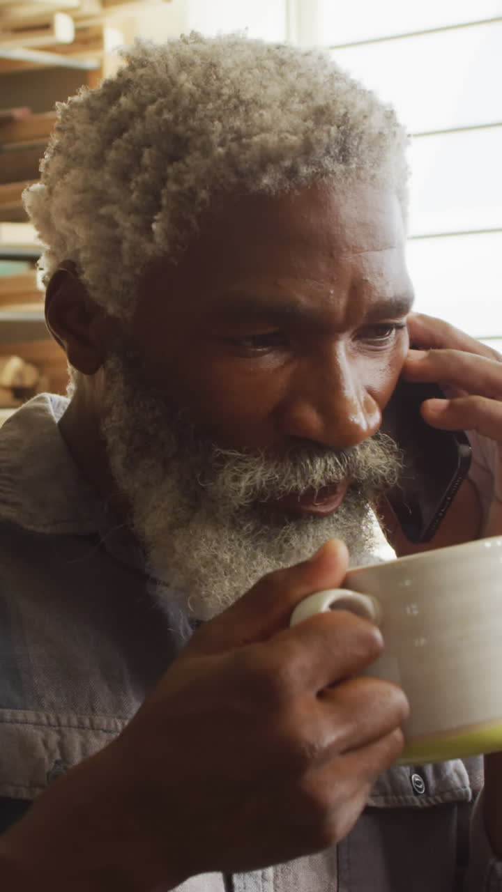 African American man talks on the phone at home