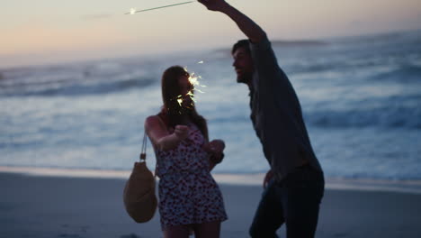 couple, beach and sparklers celebration