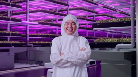 asian male scientist crossing his arms and smiling in vertical farm