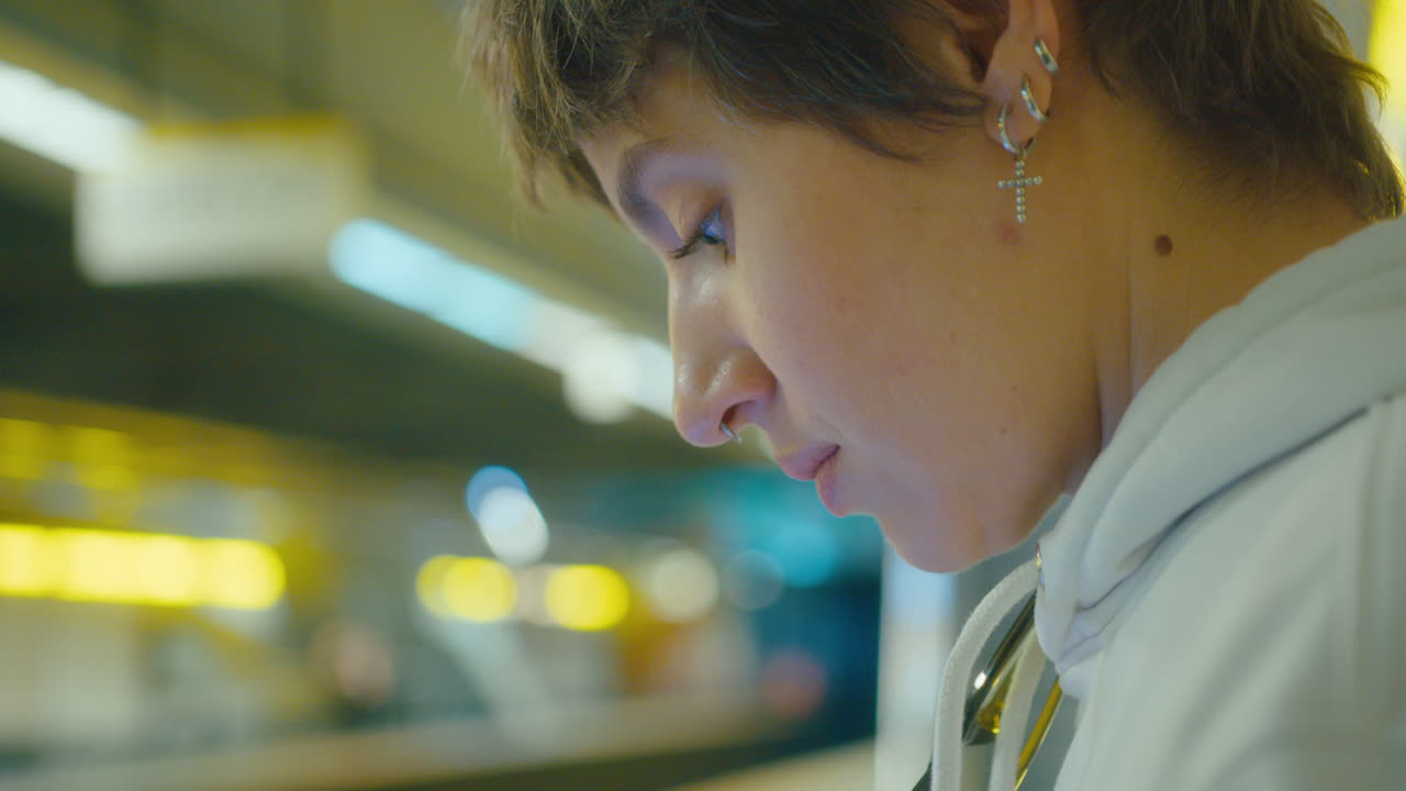 Woman Standing on Underground Station and Texting on Phone