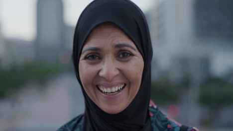 slow motion portrait middle aged muslim woman laughing happy enjoying successful urban lifestyle independent senior female wearing hijab headscarf in city at sunset