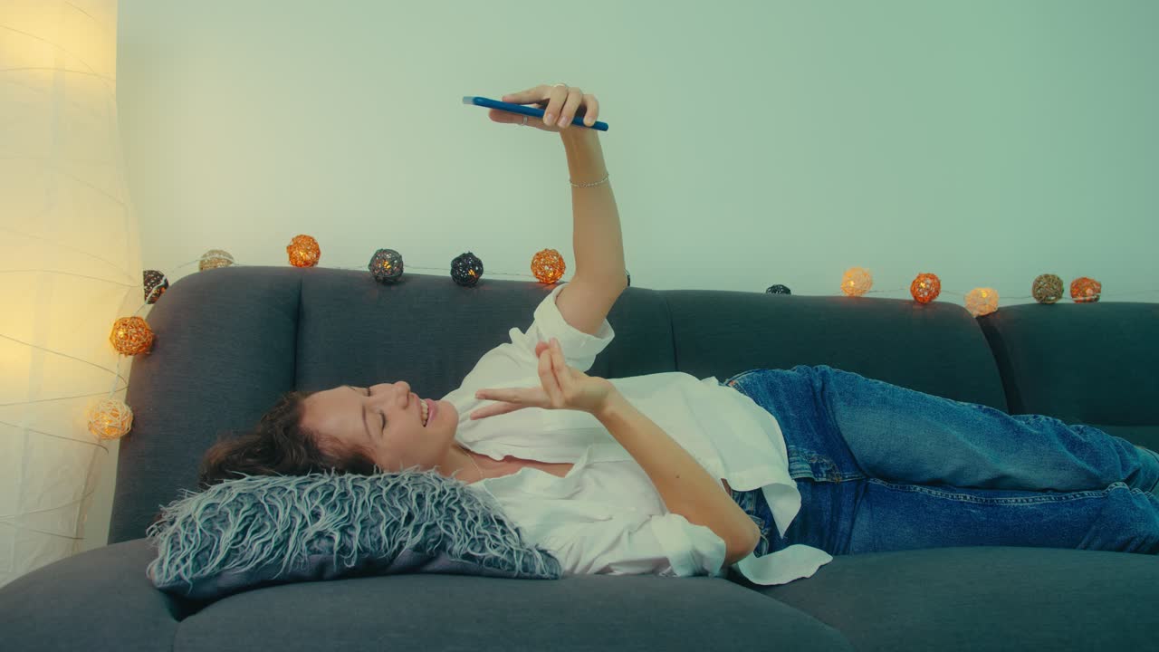 Woman Taking a Selfie on a Couch