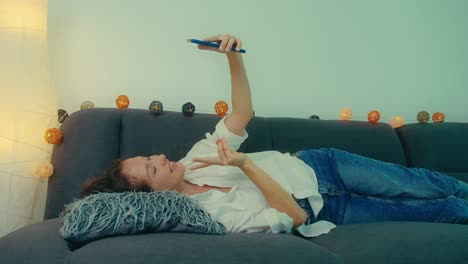 woman taking a selfie on a couch