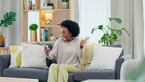 African-woman-celebrating-a-new-job-while-sitting