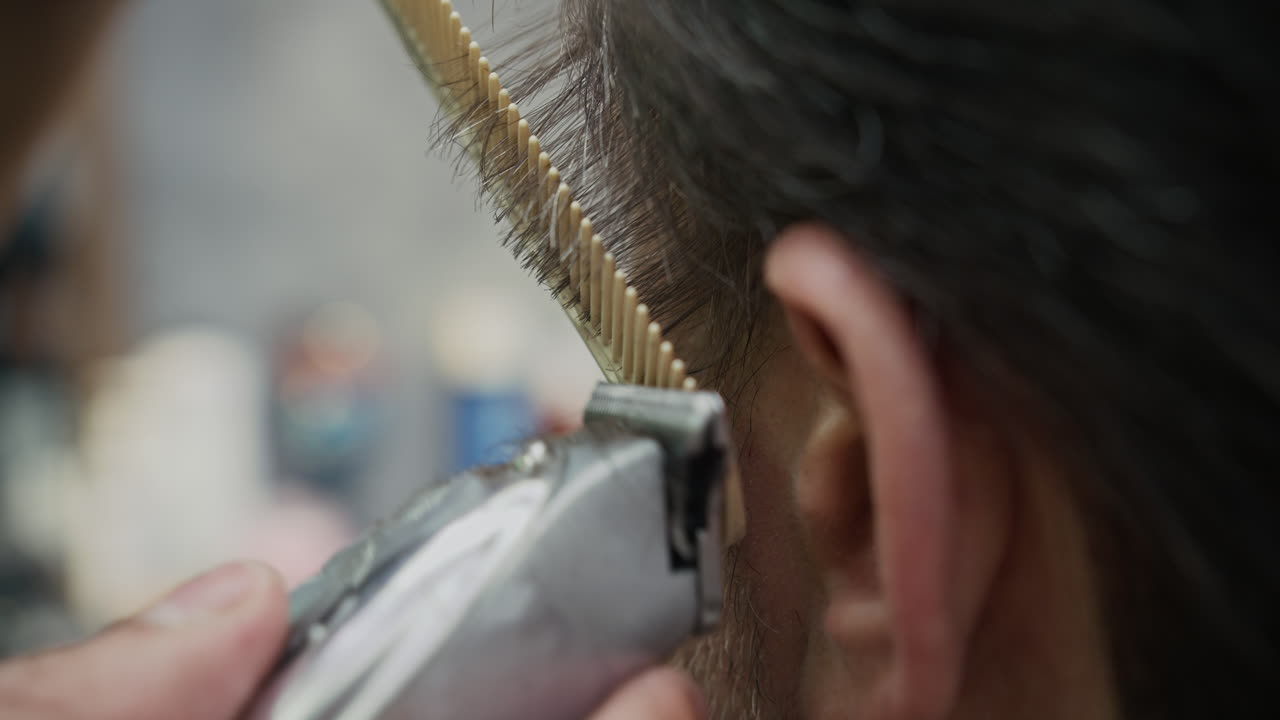 A haircut using a hair clipper and comb