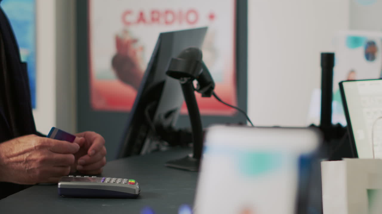 Person Paying with Credit Card at Pharmacy