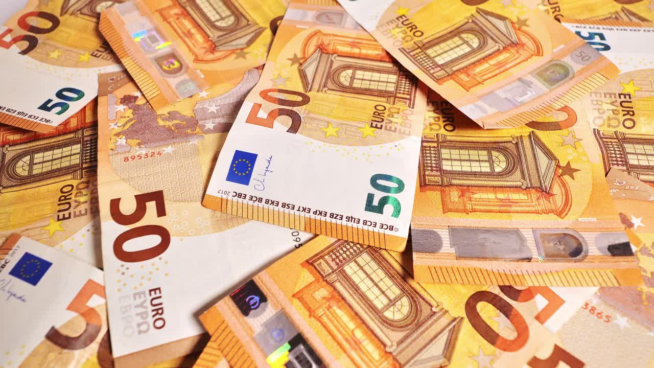 Looped rotation of crisp currency in warm light illustrates finance and economy