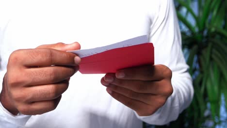 person holding a red envelope