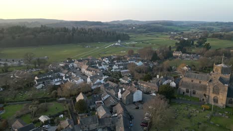 slow motion clip of the cumbrian medieval village of cartmel showing the historic cartmel priory at sunset on a winters day