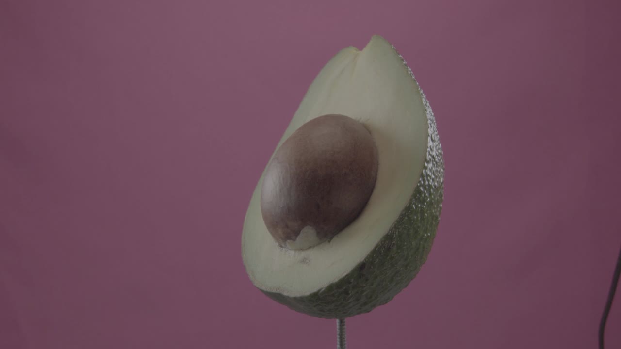 Avocado in rotazione in loop su schermo fucsia per chroma key