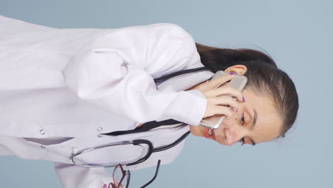 vertical video of the doctor is talking on the phone.