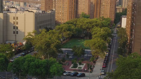 aerial static: group of teenager playing soccer on field in park of manhattan, new york city