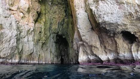 boat point of view of vedusella or verdusella caves on adriatic side of mediterranean sea, italy