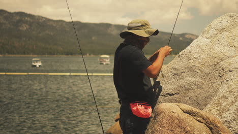 fisherman taking is time in preparing the hook with the bait on big bear lake