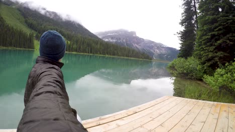 young man selfie video next to stunning lake