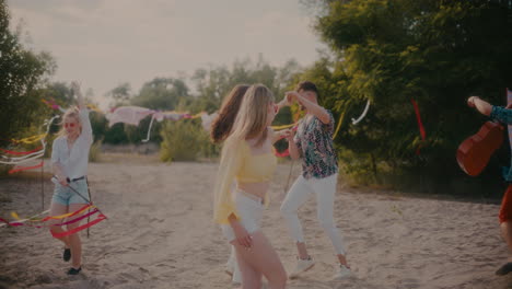 man and woman dancing bachata while friends enjoying summer weekend