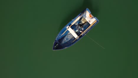 woman on the boat catches a fish on spinning in norway.