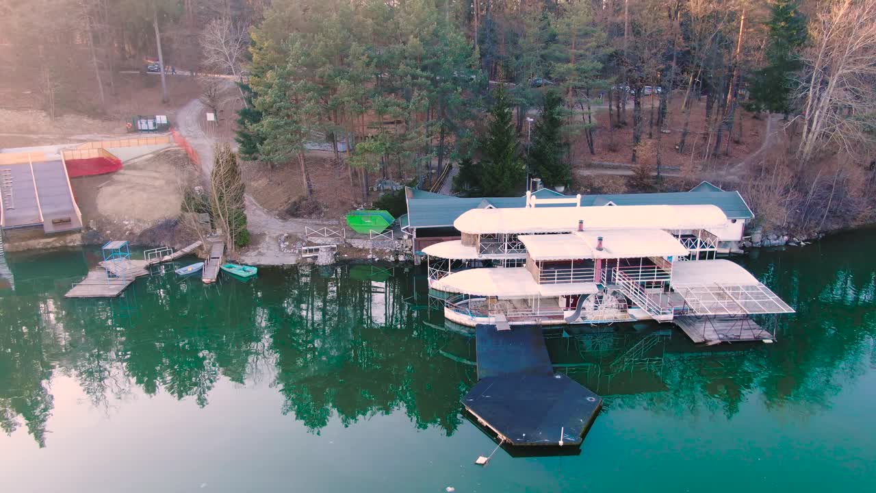 cinematic aerial view of Smartinsko lake. tourist boats and lakeside house