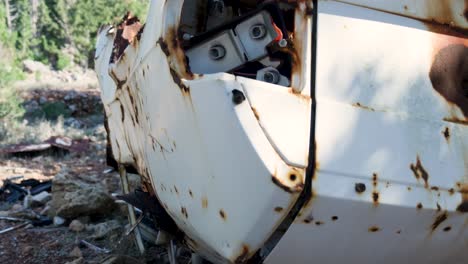 rusty, abandoned car wreck in a forest