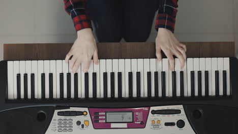 hands playing electric keyboard close up