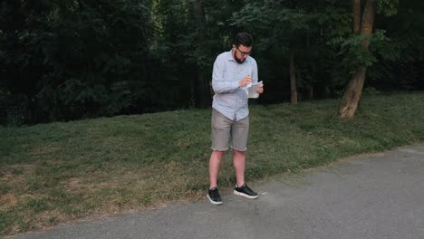 Man-with-glasses-writes-in-a-notebook