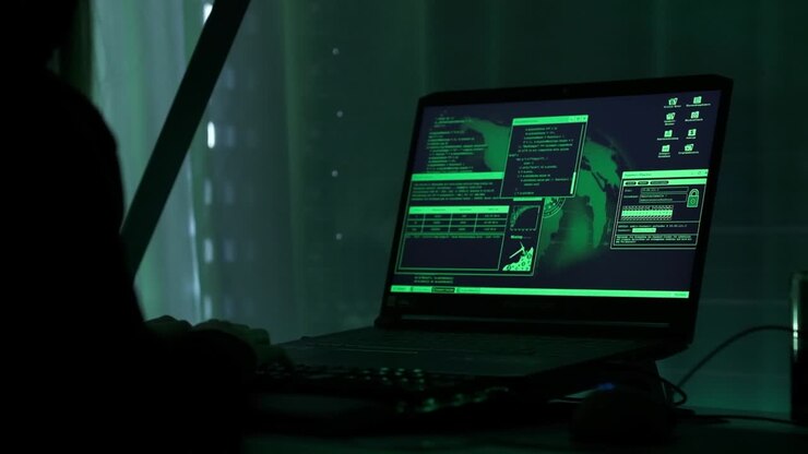 una ragazza hacker criminale con cappuccio nero che utilizza laptop e grandi computer per hackerare il sistema di rete dalla sua oscura stanza al neon hacker