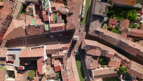 Comacchio,-Italy,-drone-top-down-view-of-urban-infrastructure,-city's-canal,-little-Italian-city,-sunny-weather