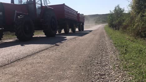 Two-utility-wagon-tractor-passing-by-on-a-remote-countryside-road