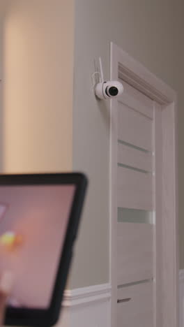 wireless security camera on wall by door