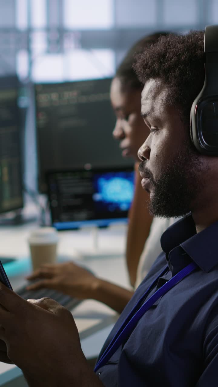 Vertical video Data center IT expert texting on smartphone, taking break