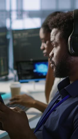 vertical video data center it expert texting on smartphone, taking break