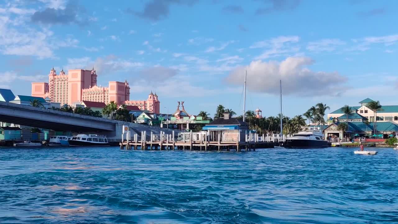 Coming to Hotel Atlantis in The Bahamas by a boat 4K 30 FPS sailing boat crossing under a bridge during the day