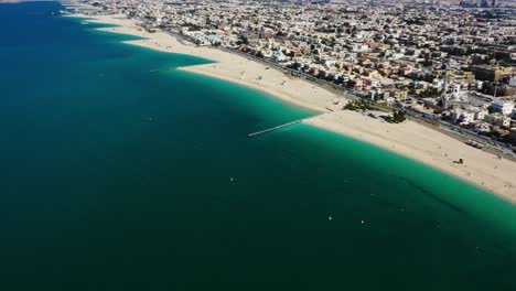 drone video of dubai city at day time, modern city concept with water and transport