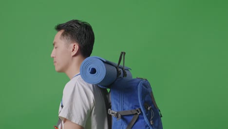 man with backpack on green screen