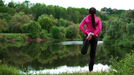the girl warms up early in the morning before training preparing for a run in the sun