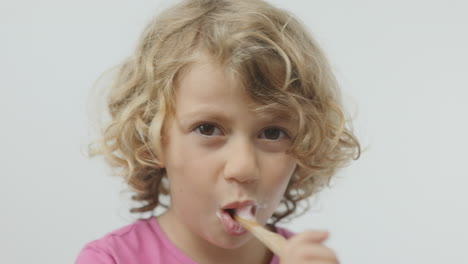 small girl brushing her teeth