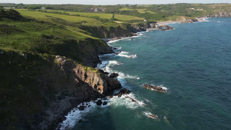 a drone view of the rugged coastline on the south coast of cornwall, england near the village of kuggar and kennack sands popular with holidaymakers.