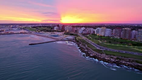 aerial pan left of ocean shore waterfront mar del plata, vibrant scenic sunset, argentina