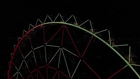 Aerial-close-up:-Ferris-wheel-at-Aztlan-Parque-Urbano-with-Mexico-City´s-skyline-as-background-at-night